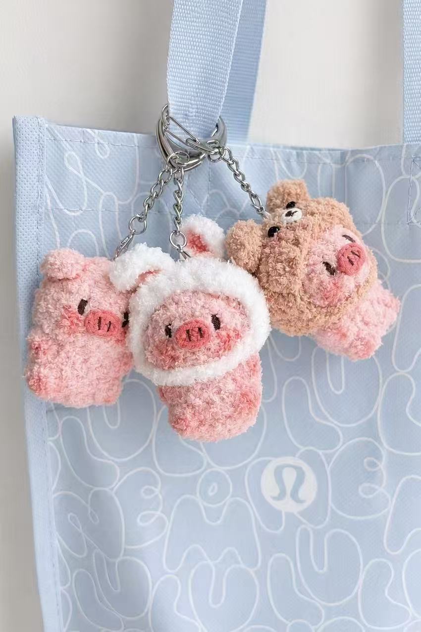 Handmade crochet pink pig keychain on a tote bag